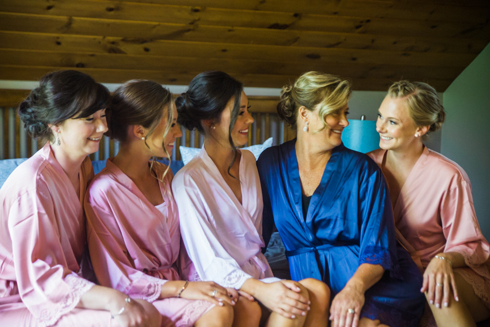 bride with her mom and sisters in robes