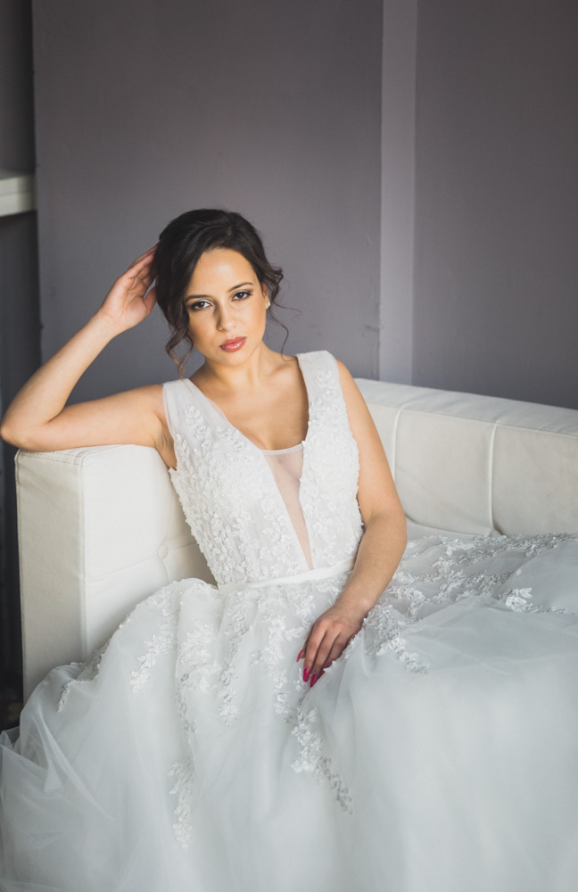 Bride sitting on couch by window
