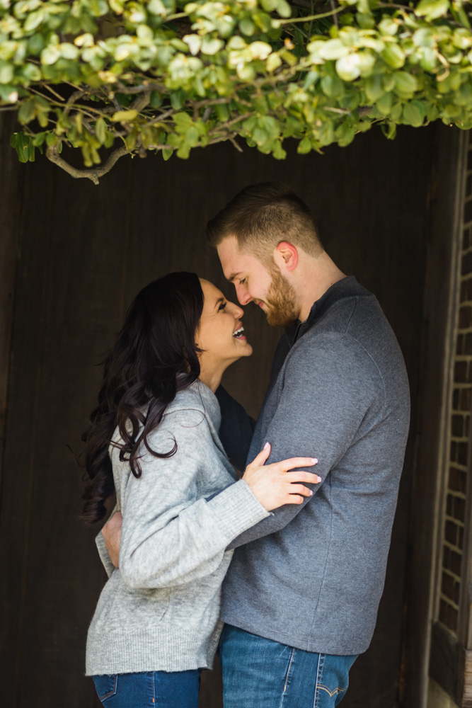 couple smiling at each other at engagement session