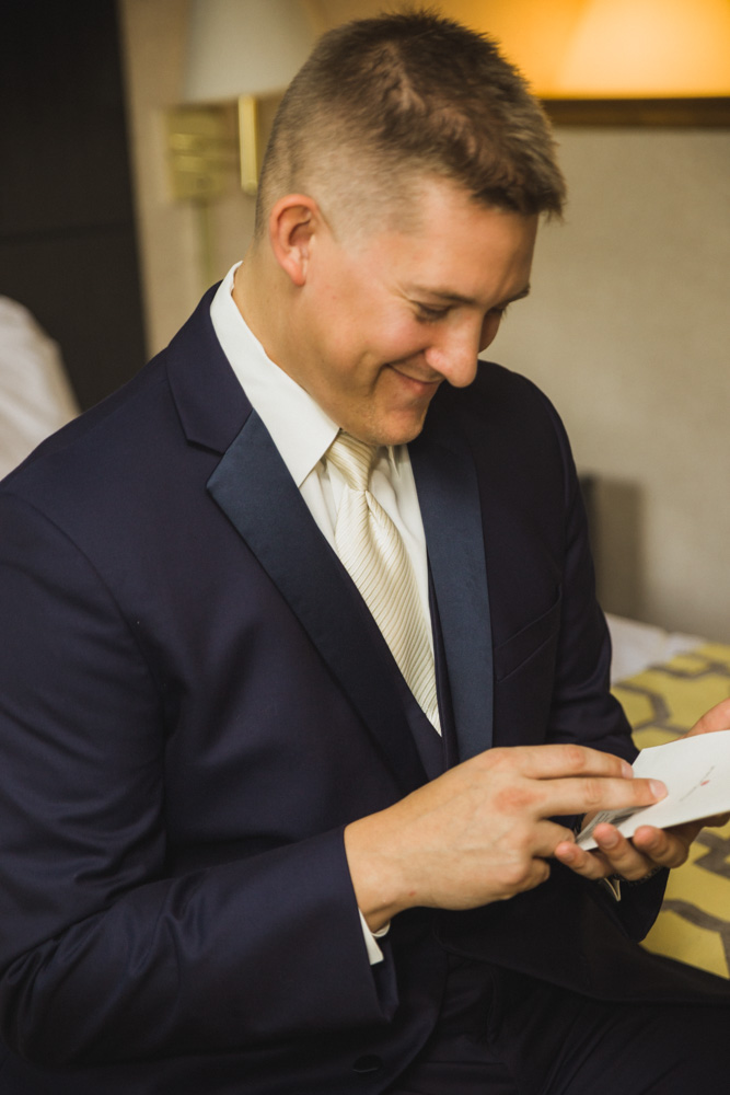 groom reading letter from bride before woodwinds connecticut wedding