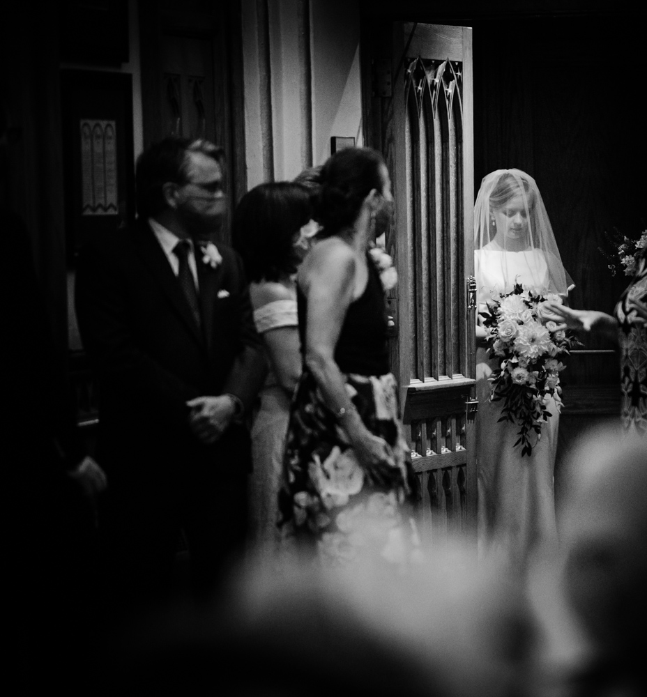 black and white photo of bride before she walks down the aisle
