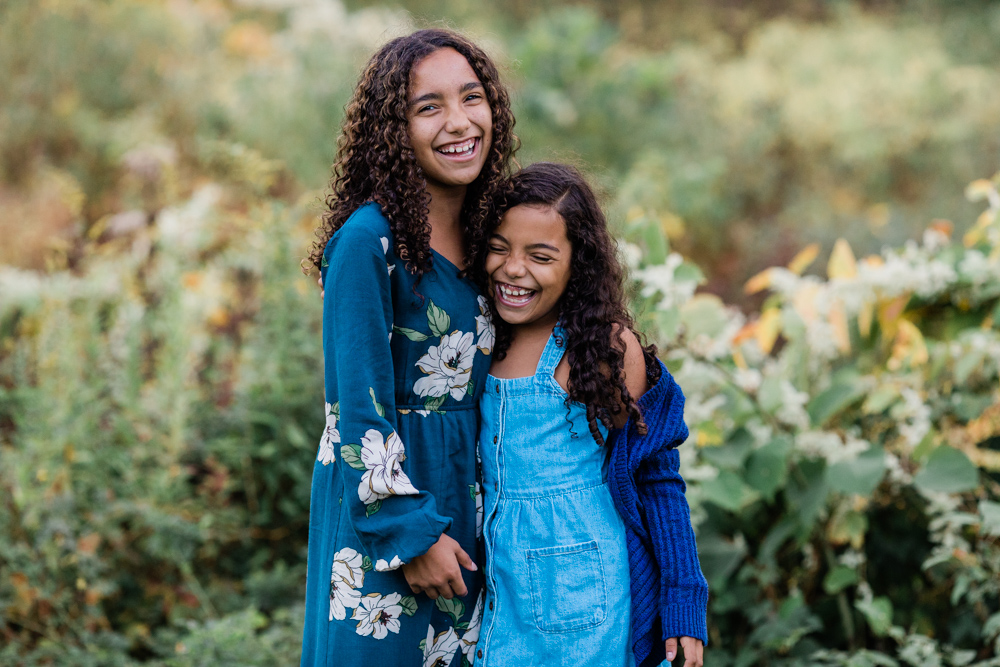 SIsters laughing at their family session at hubbard park