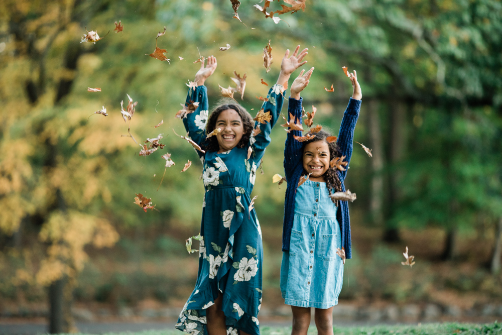 sisters throwing leaves at hubbard park