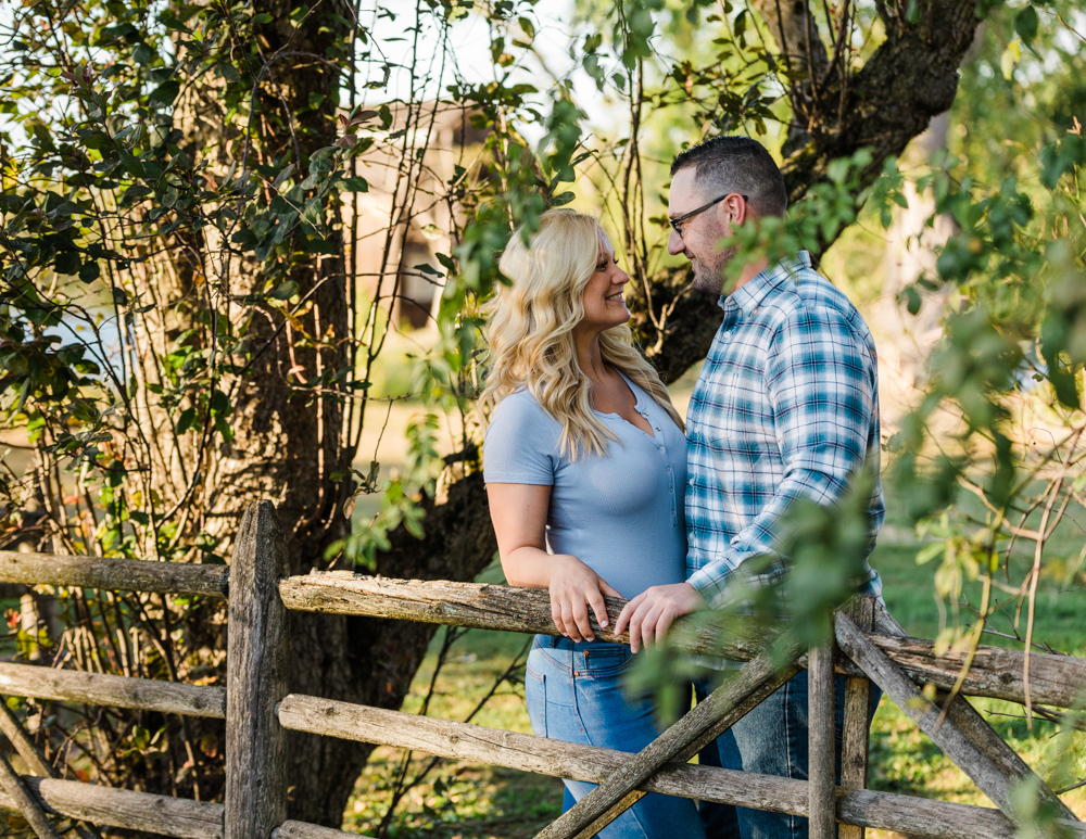 couple by the fence at their wethersfield cove engagement session