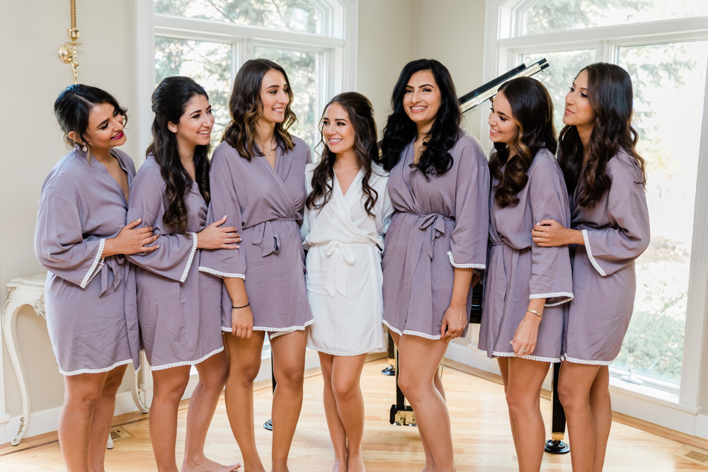 bride and bridesmaids in robes before her hillstead museum backyard wedding 