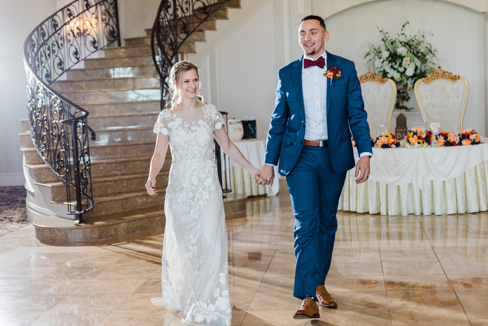 brid and groom walking into their aria fall wedding reception