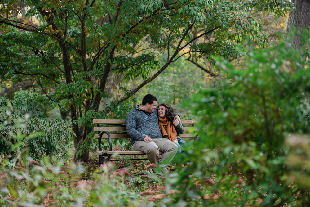 couple sitting on a bench for their yale edgerton park engagement session