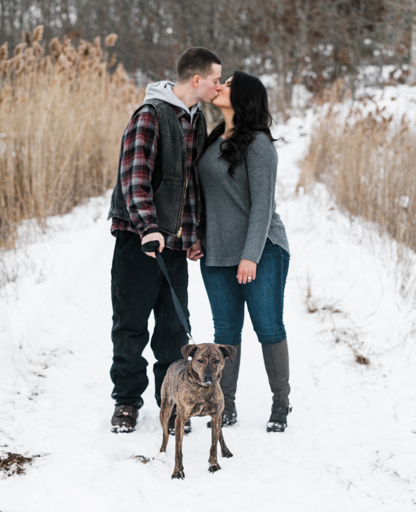 couple on a walking path with their dog at their Connecticut engagement photos