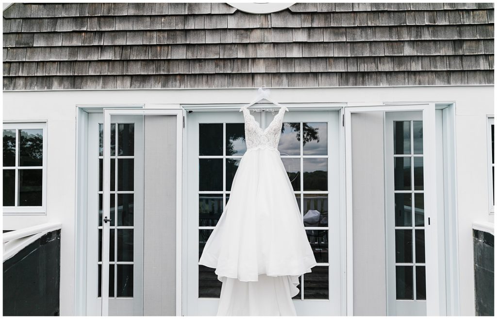 paloma blanco wedding gown hanging at the Fox Hopyard Golf Club