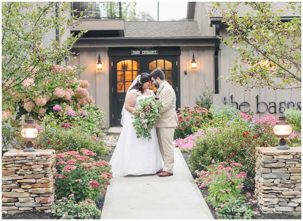 A couple standing in front of the barns at their Stonehurst at Hampton Valley wedding 