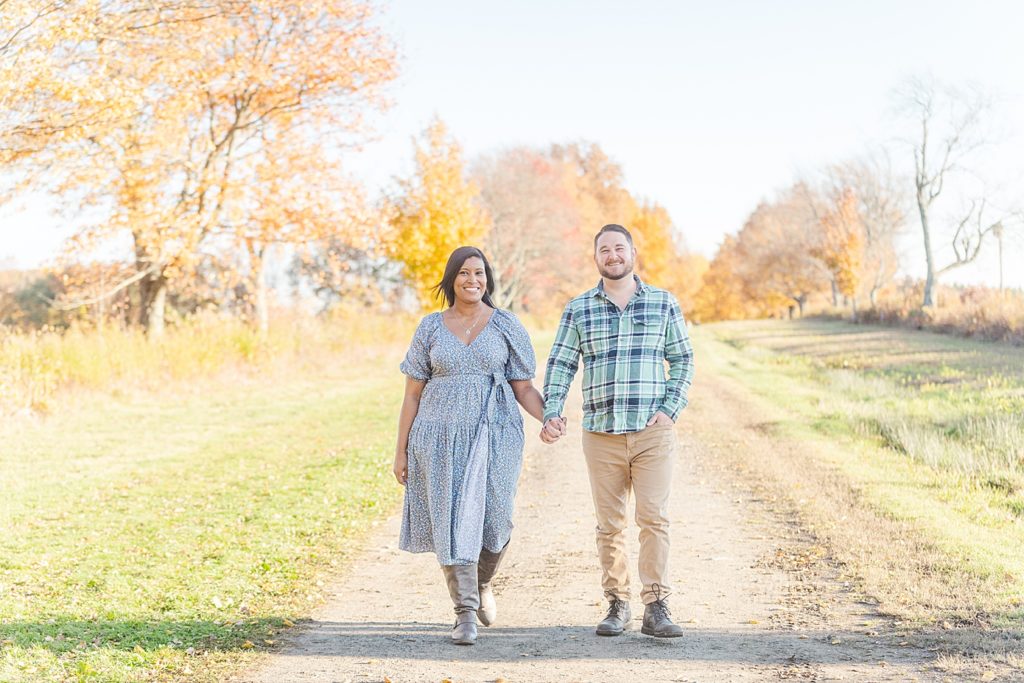 couple walking at their fall topsmead forest engagement session
