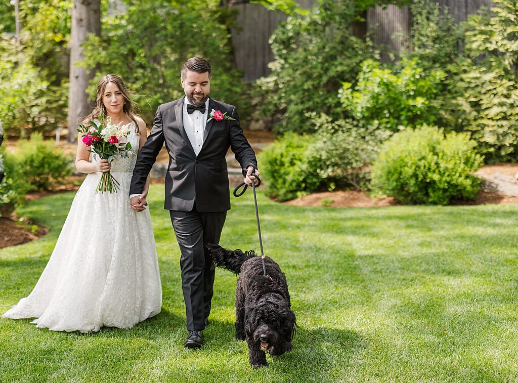 bride and groom walking their dog at their spring hops company garden wedding